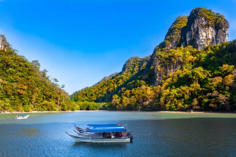 Tourist boats in a big lake with tall mountains around