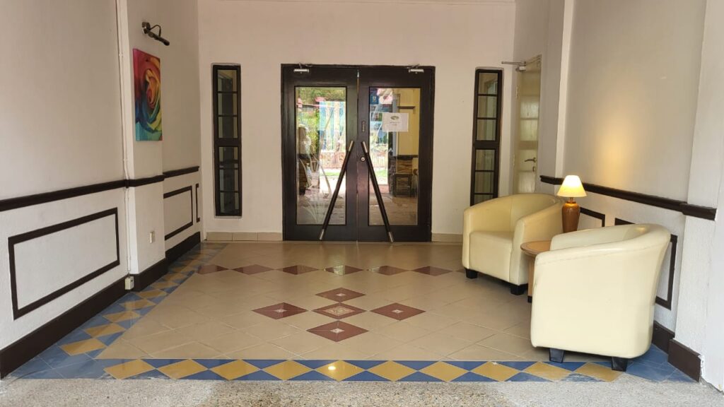 A front entrance of Oriental Village Boutique Hotel lobby with chairs